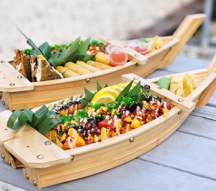 two wooden boats filled with food sitting on top of a table