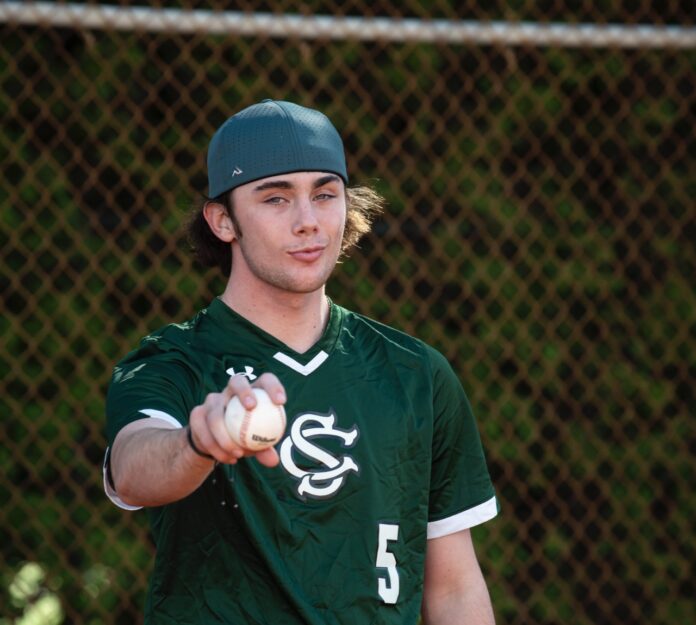 a man in a baseball uniform throwing a ball