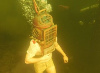 a person wearing a diving mask and diving in the water