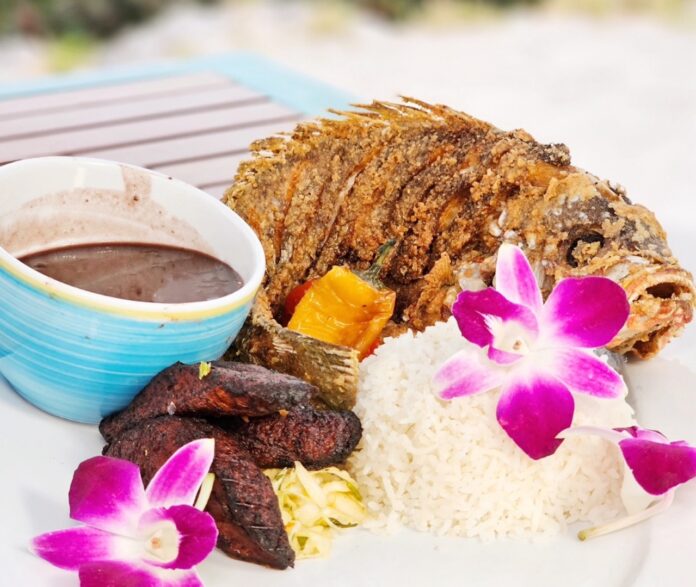 a plate of food on a table with a bowl of dipping sauce