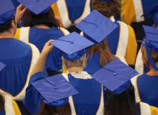 a group of graduates in blue caps and gowns