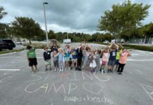 a group of children standing in a parking lot