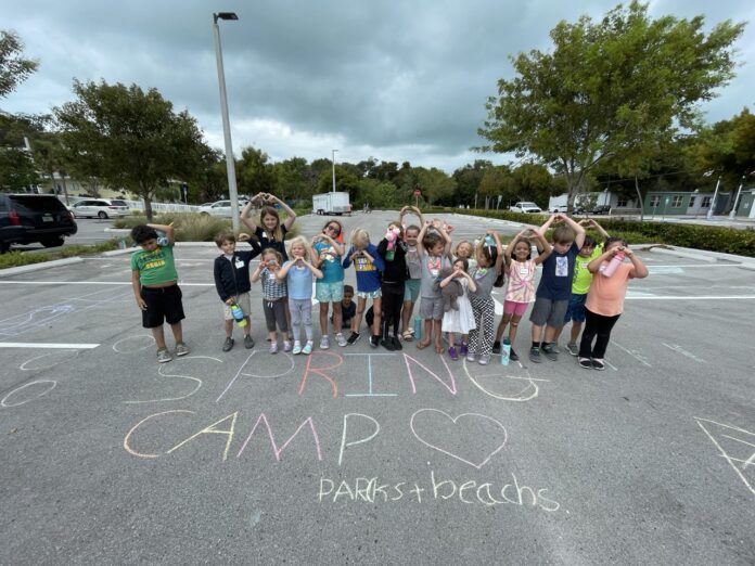 a group of children standing in a parking lot