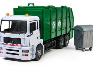 a green and white truck next to a trash can