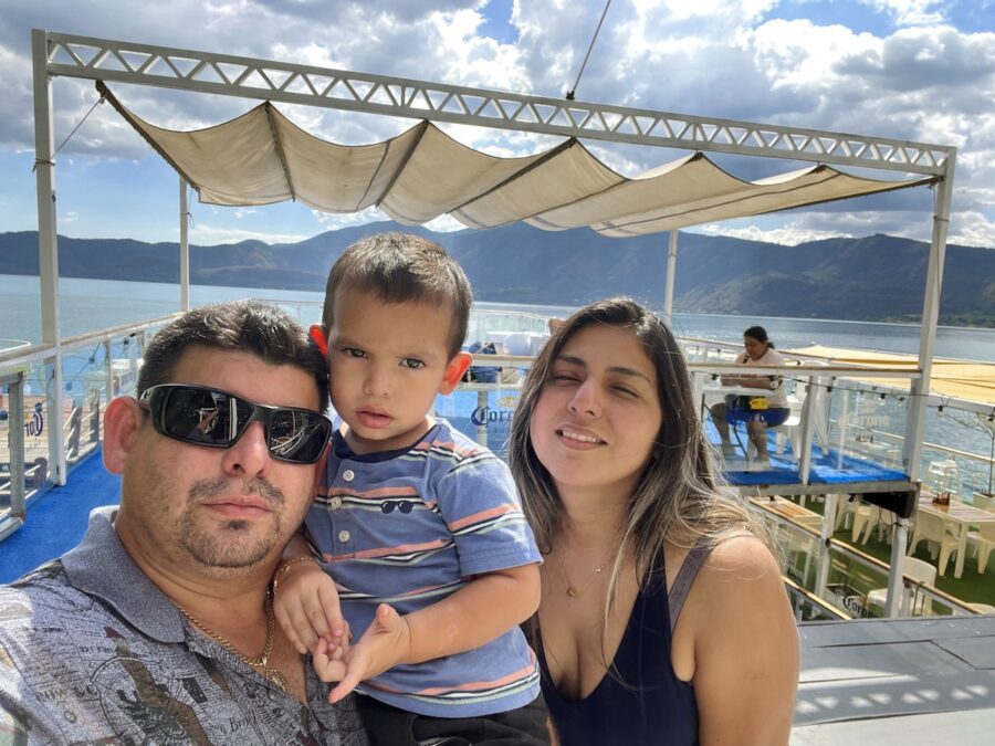 a man, woman and child posing for a picture on a boat