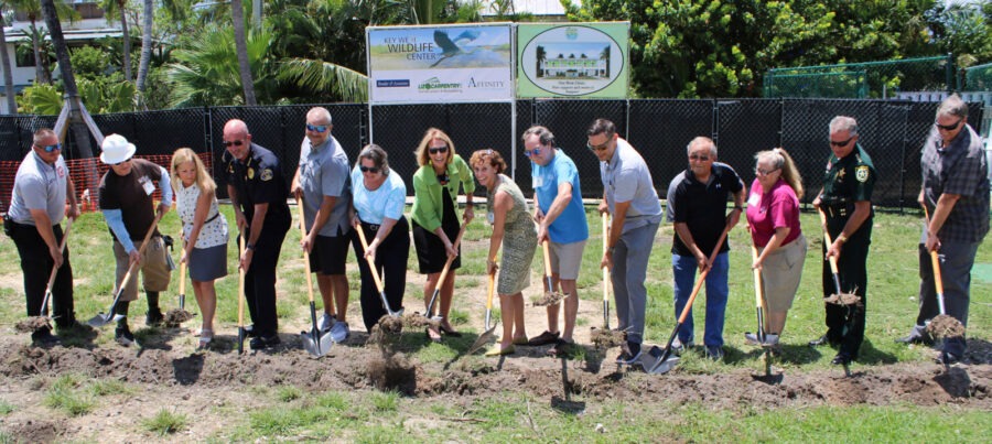 a group of people with shovels standing in the dirt