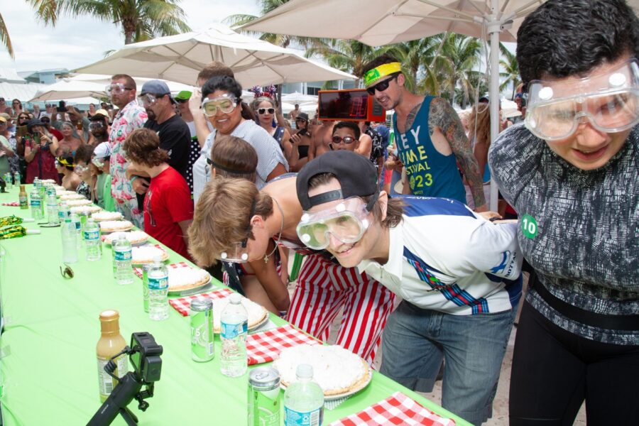 a group of people standing around a long table