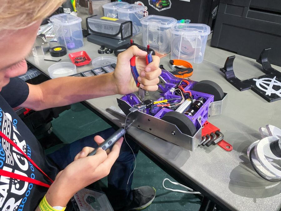 a young man is working on some electronics