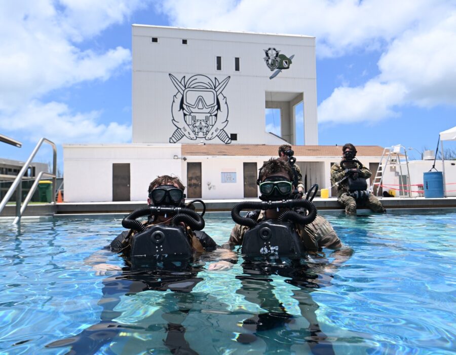 a group of people in scuba gear in a pool