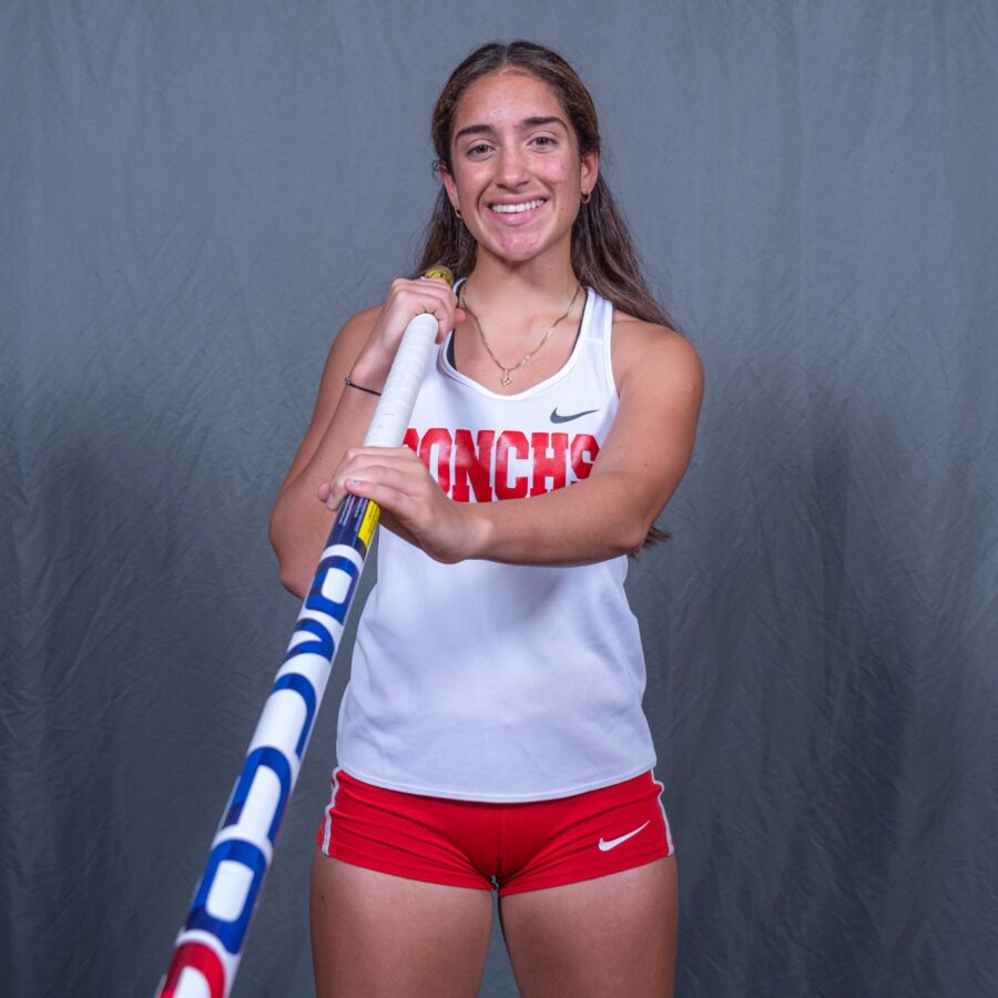 a woman in red shorts holding a baseball bat