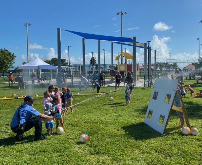 a group of people playing with balls in a field