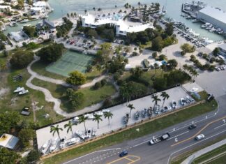 an aerial view of a marina with a tennis court