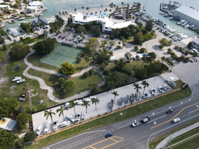 an aerial view of a marina with a tennis court