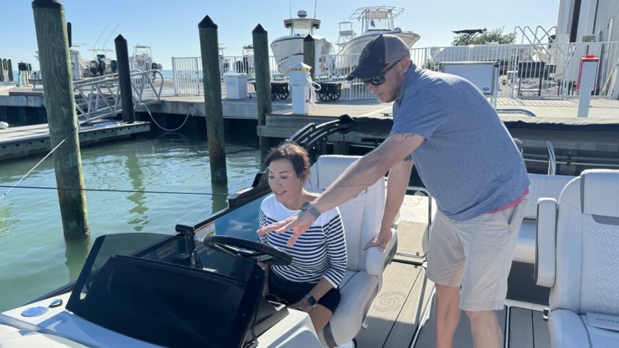 a man standing next to a woman on a boat