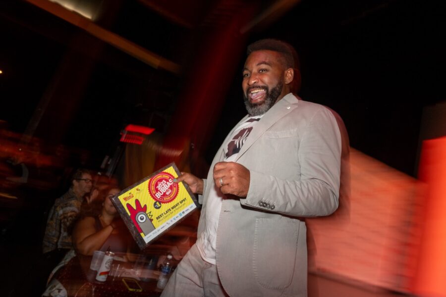 a man in a gray suit holding a yellow box