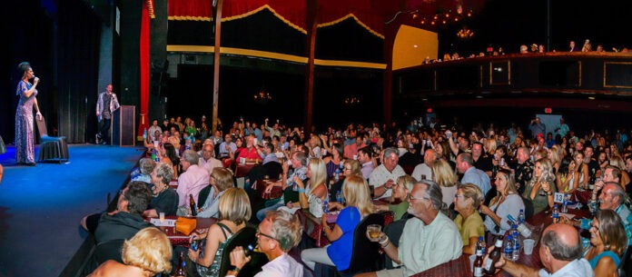 a large group of people sitting in a room