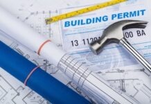 a hammer, a ruler, and some blueprints