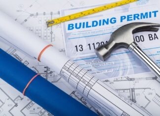 a hammer, a ruler, and some blueprints