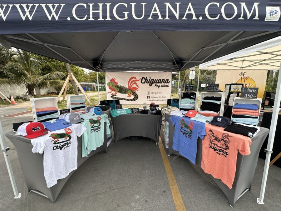 a tent with shirts on display under it