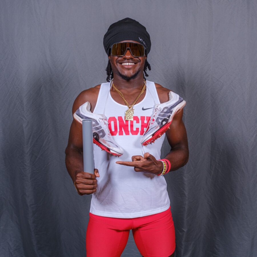 a man in red shorts and a white tank top