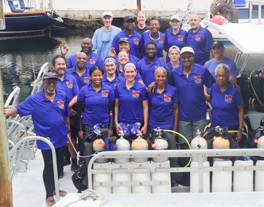 a group of people on a boat posing for a picture