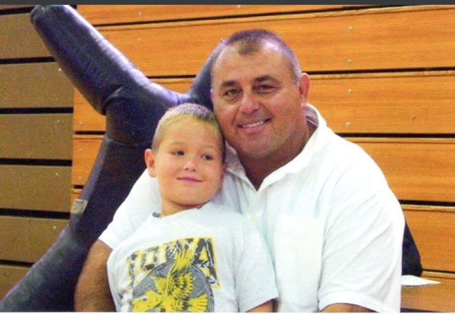 a man sitting next to a little boy