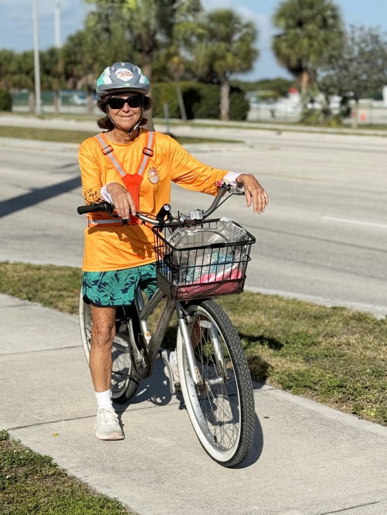 a man riding a bike down a sidewalk