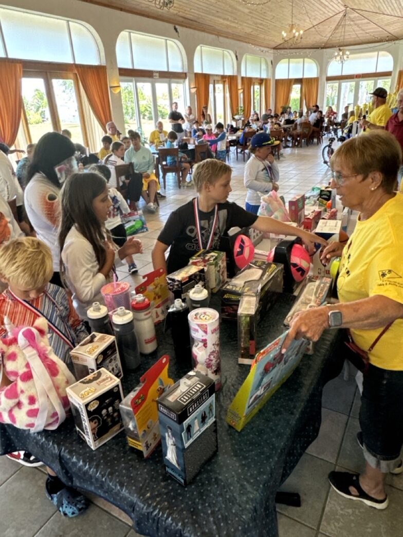 a group of people standing around a table