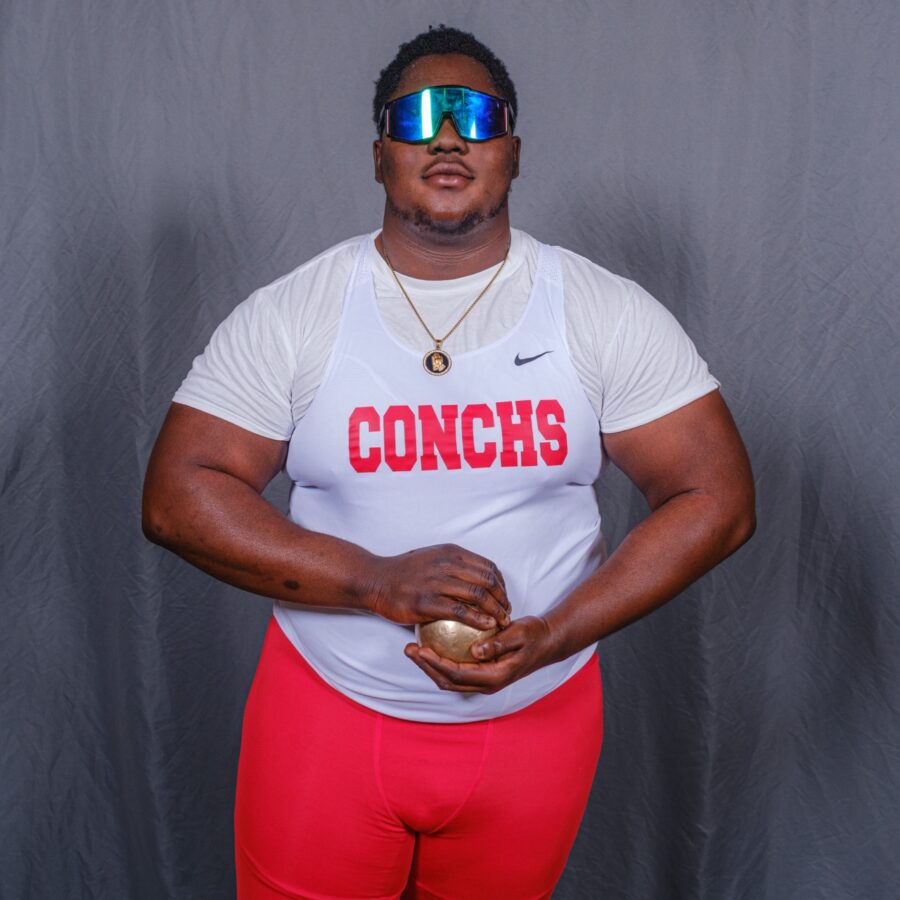 a man in red shorts and a white shirt