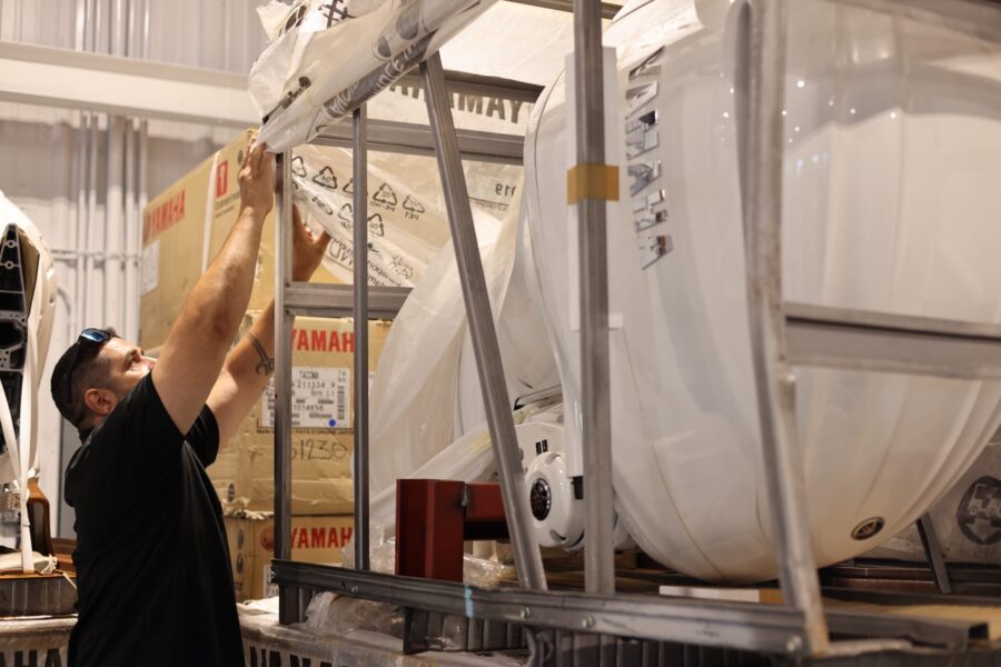 a man is working on a boat in a warehouse