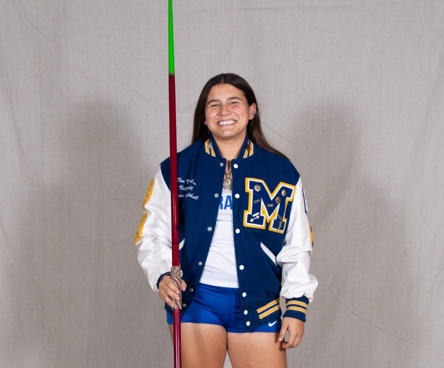 a woman in a cheer uniform holding a pole