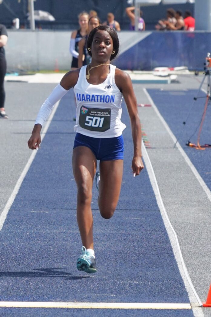 a woman running on a race track