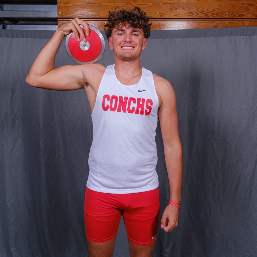 a man holding a red frisbee in his right hand