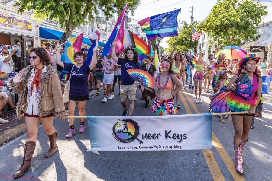 a group of people walking down a street holding flags
