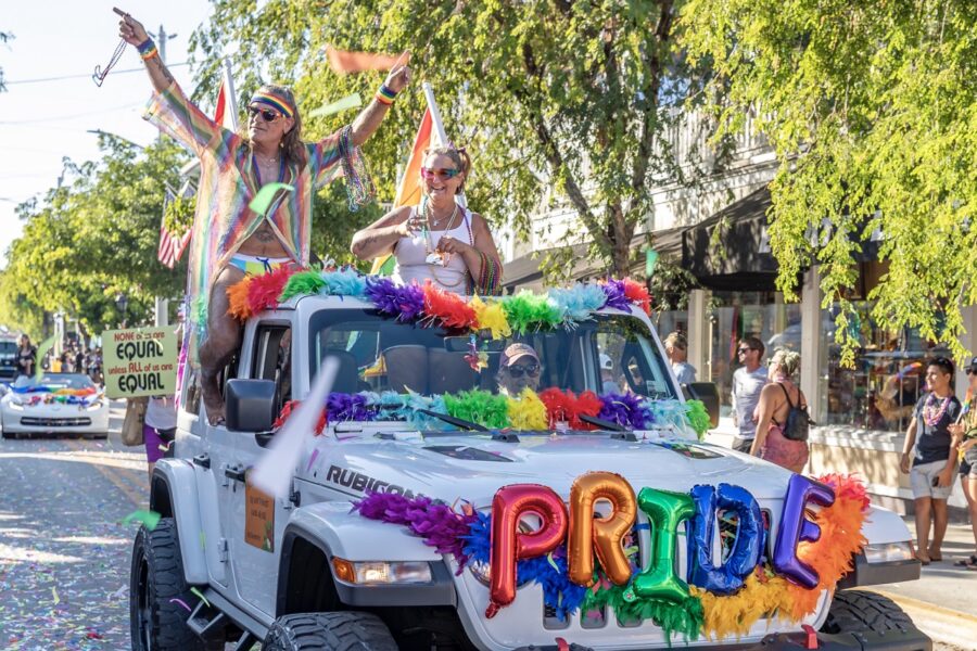 two women are riding in the back of a jeep