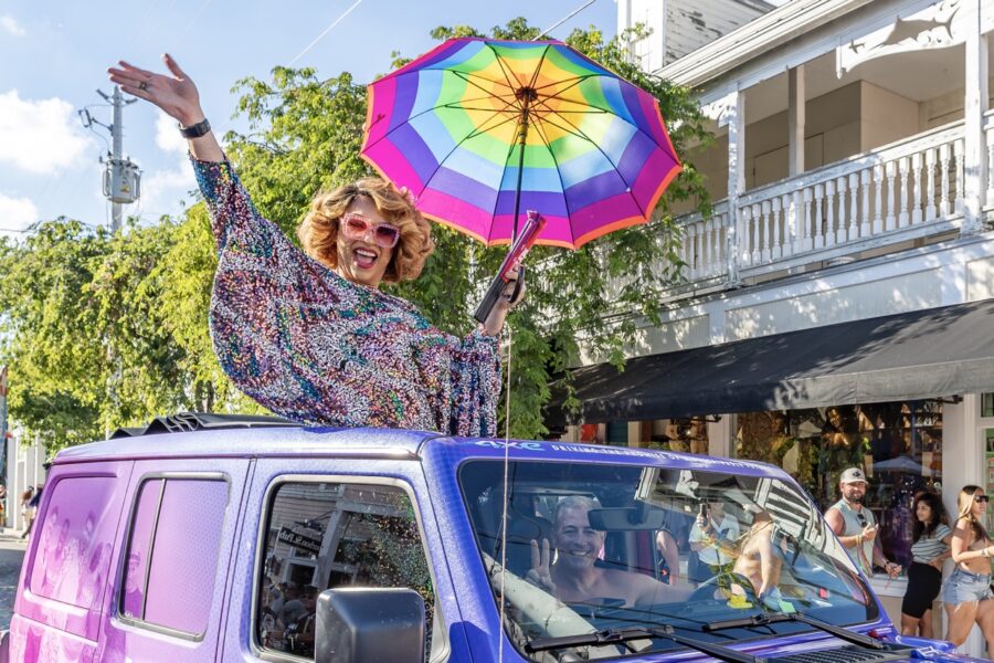 a woman with an umbrella on top of a van