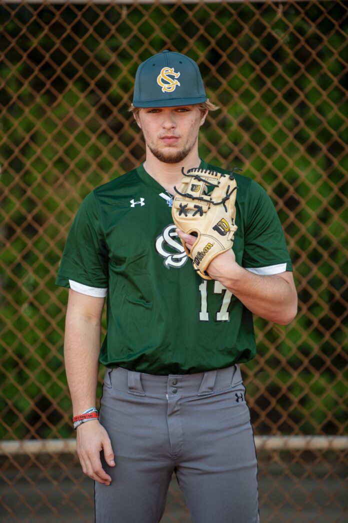 a man in a baseball uniform holding a glove