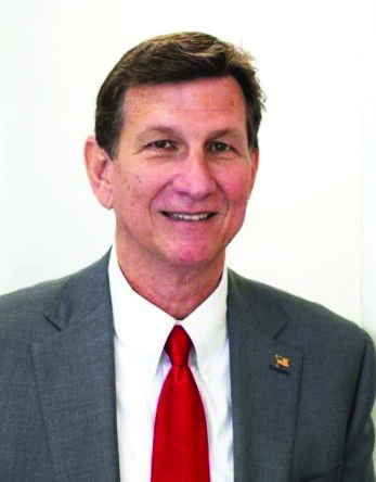 a close up of a person wearing a suit and tie