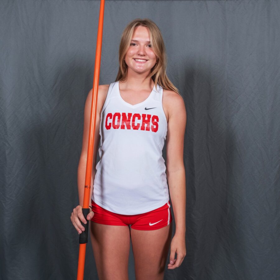 a woman in red shorts holding a baseball bat