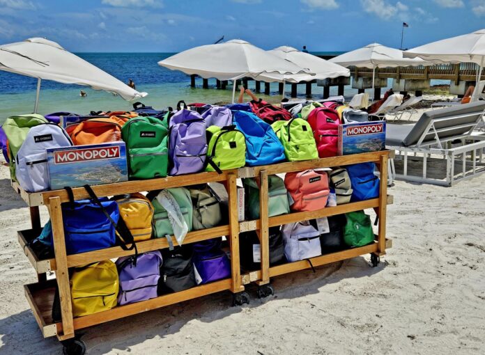 a wooden cart filled with bags on top of a beach