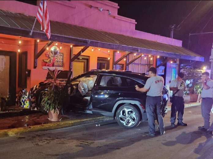 a group of people standing around a car