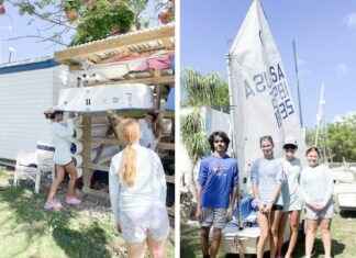 a group of people standing around a boat