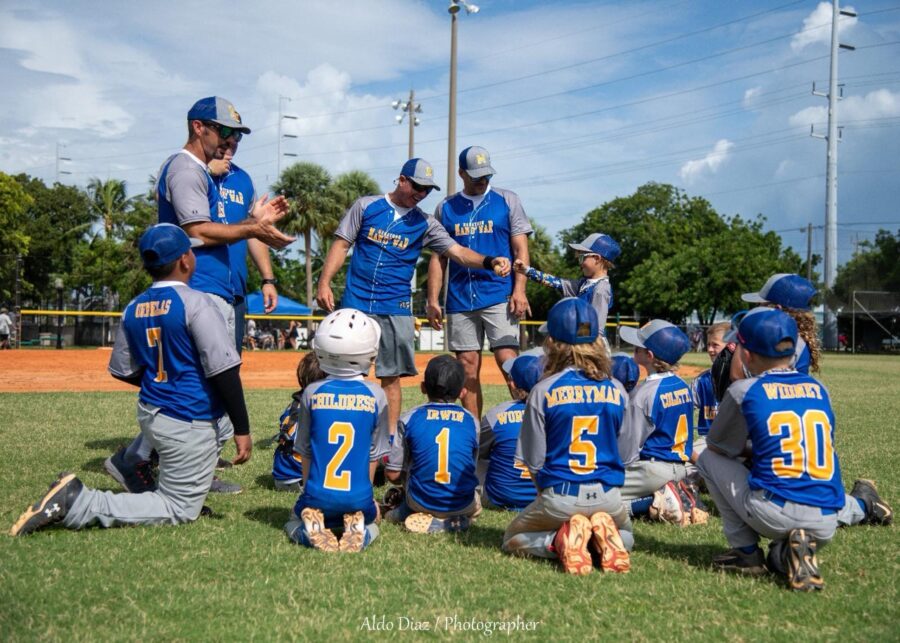 a group of baseball players sitting on top of a field