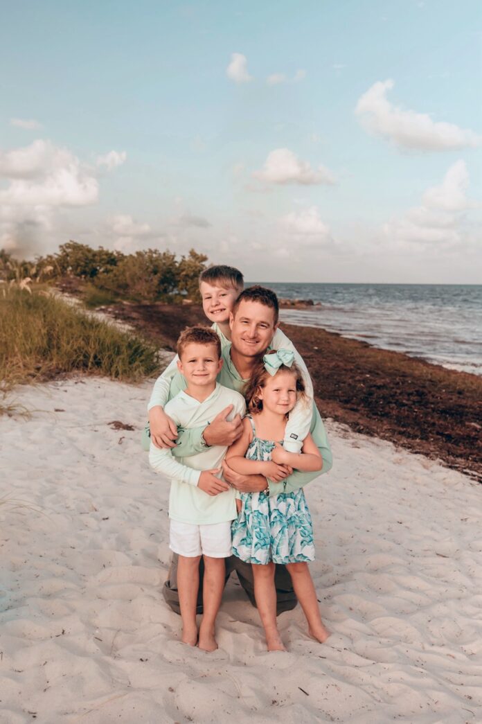 a family poses for a photo on the beach