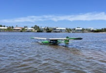 a small plane floating on top of a body of water