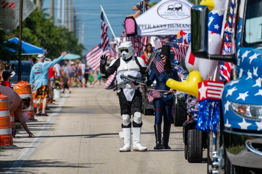 a group of people in costumes walking down a street