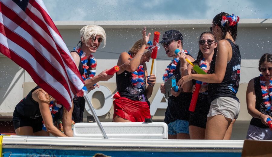 a group of people on a boat with an american flag