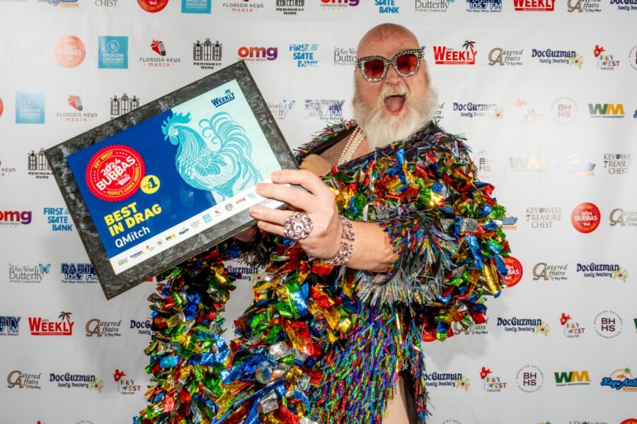 a man in a costume holding a plaque