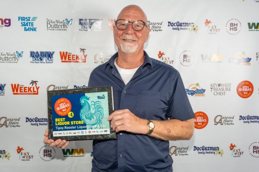 a man holding a plaque in front of a white background