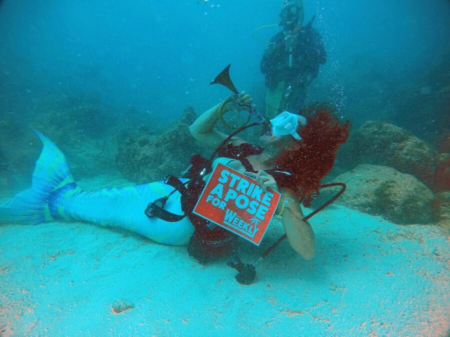 a man laying on the ground with a trumpet in his hand